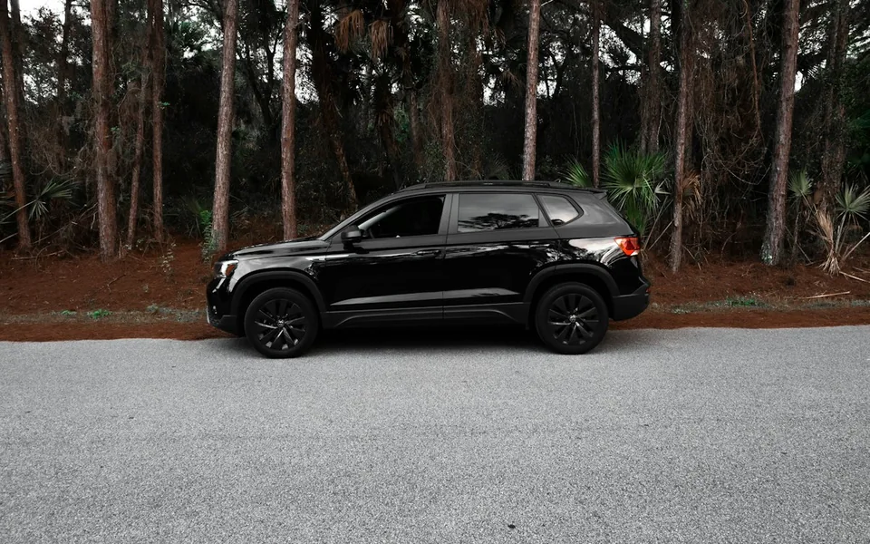 Premium black SUV beside a tree-lined road